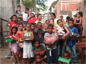Children in Venezuela holding shoeboxes.