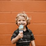 smiling boy holding ice cream cone