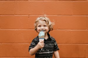 smiling boy holding ice cream cone