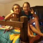 two girls sitting on a bunkbed