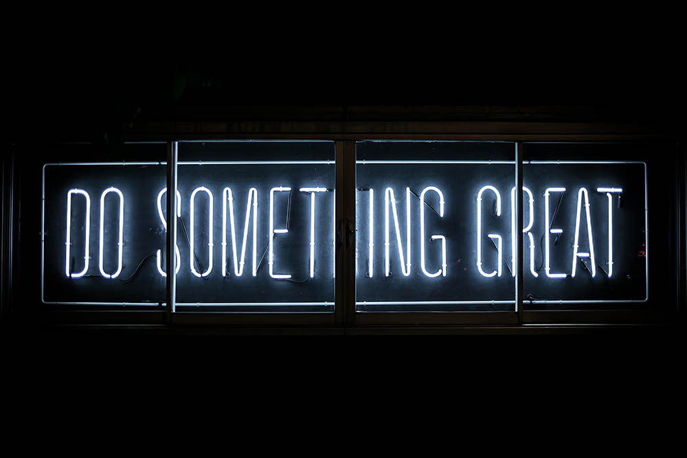 neon sign that says Do Something Great