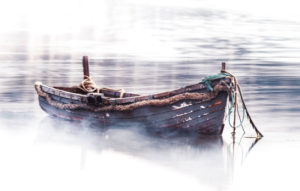 rowboat sitting in fog in still water