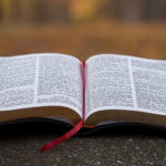 Bible open with red ribbon